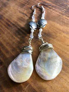 the earrings are made out of mother's day shells and wire wrapped in silver