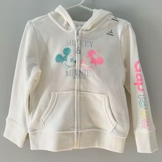 Nwt Gap Kids And Disney’s Mickey Mouse & Minnie Mouse White Zip Up Hooded Sweatshirt ** New With Tags ** New And Never Used. All Stickers And Tags Still On. Beautiful Bright White With Neon Pink And Blue. I Love The Gap Logo 1969 On The Left Arm Especially. 77% Cotton 14% Polyester 9% Recycled Polyester Size: 3t (90cm) Gently Preowned And Always Happy To Put A Bundle Together With Other Items At A Discount. Smoke Free - Pet Free Home Cotton Hoodie With Adjustable Hood For Playtime, Gap Cotton Hooded Top, Sporty White Gap Tops, Cotton Hoodie For Playtime, Cute White Outerwear With Drawstring Hood, Cute Cotton Hoodie For Playwear, Pink Cotton Hoodie By Gap, Gap Pink Winter Hoodie, White Sweatshirt For Playwear In Fall