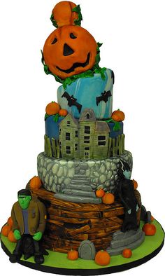 a three tiered halloween cake with pumpkins on top