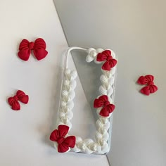 the letter d is decorated with red and white bows on it's side, along with other decorative items