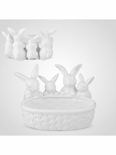 three white rabbits sitting in a basket next to each other