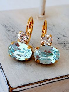 "Ice blue and clear diamond crystal drop earrings, Icy light aquamarine European earring, Dangle earrings, Bridal earring, Bridesmaids gifts, Gold earring THESE EARRINGS CAN BE CUSTOM MADE WITH YOUR REQUEST FOR OTHER COLORS -Please just contact me. Elegant and refined. These would be great as bridal earrings or for any available other day. Perfect gift for bridesmaids or other occasions. They are made of gold plated plated brass and Swarovski crystals, set in prong setting. Made with CRYSTALLIZE Wedding Dangle Earrings, Fairy Clothing, Light Blue Earrings, Bridal Earring, Dangle Earrings Wedding, Crystal Earrings Wedding, Crystal Bridal Earrings, Earring Dangle, Aquamarine Earrings