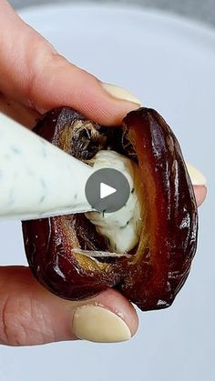 someone is peeling an eggplant in the middle of their thumbnails to eat it