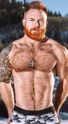 a man with a red beard and no shirt is standing in the snow wearing boxer shorts