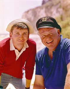 two men in hats pose for a photo