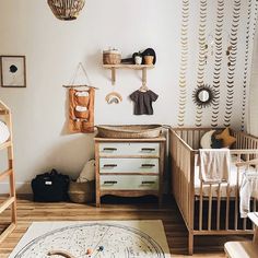 a baby's room with two cribs and a rug on the floor