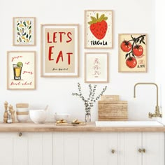 a kitchen with white cabinets and pictures on the wall above it that says let's eat