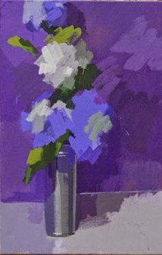 a vase with some flowers in it sitting on a table next to a purple wall