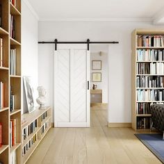 a living room with bookshelves full of books and a door leading to the bedroom