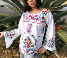 Well designed and well embroidery only for you. Mexican blouse embroidered flowers bell sleeve. This is a blouse embroidered by hand with beautiful colorful flowers. Very comfortable, Goes great with jeans, leggings, skirt, shorts... Each piece is unique and handmade with dedication and taking care of every detail achieving the best quality in our products, which is why it makes it beautiful and unique each of the embroidered flowers. More style, check the following link: https://www.etsy.com/mx Traditional Long Sleeve Blouse With Embroidered Cuffs, Traditional White Long Sleeve Top, Traditional Cotton Tops With Embroidered Cuffs, Traditional Cotton Blouse With Embroidered Cuffs, Folk Style Long Sleeve Top With Embroidered Cuffs, White Long Sleeve Tops With Intricate Embroidery, Folk Style Long Sleeve Tops With Motif, Spring Motif Long Sleeve Blouse, White Long Sleeve Blouse With Intricate Embroidery