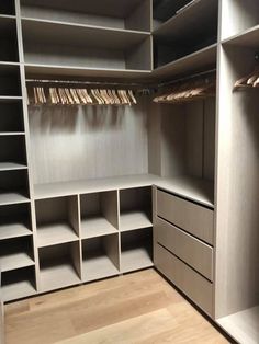 an empty walk in closet with shelves and drawers