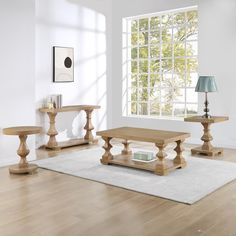 a living room with white walls and wooden furniture on the hardwood floor, along with a large window