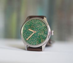 Custom  made watch, Swiss made movement  ETA 6498, custom mechanical wind up watch, Green enameled dial  - movement:mechanical, incabloc 17jewels, manual winding Case material: 316L stainless steel Case size: 44 mm Lug to lug: 52mm Glass : mineral Thickness:12mm Band Width: 22mm See more of our watches: https://www.etsy.com/shop/RetroWatchMZLtd Watch Green, We Watch, Wristwatch Men, Swiss Made, Wrist Watches, Cool Watches, Quartz Watch, Stainless Steel Case, Bulgaria