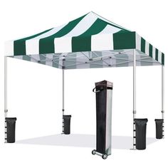 a green and white striped tent with two black trash cans under it, on a white background