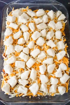 a casserole dish filled with cheese and chicken