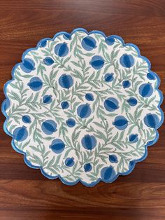 a blue and white plate sitting on top of a wooden table