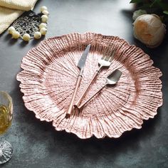 a pink plate with two forks on it