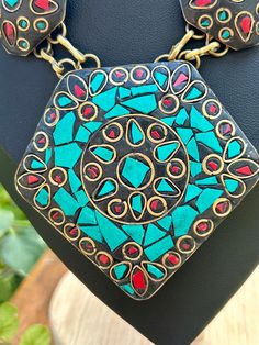 Vintage Tibetan turquoise and coral inlaid in brass. Adjustable length from 18"-20". Very nice vintage condition. Vintage Turquoise Necklace For Festival, Traditional Blue Patina Necklace, Traditional Turquoise Inlay Necklace As Gift, Traditional Turquoise Necklace With Inlay For Gift, Handmade Turquoise Brass Necklace, Artisan Gold Turquoise Necklace For Festival, Artisan Turquoise Necklace In Gold For Festival, Unique Turquoise Brass Necklaces, Bohemian Turquoise Inlay Necklace As Gift