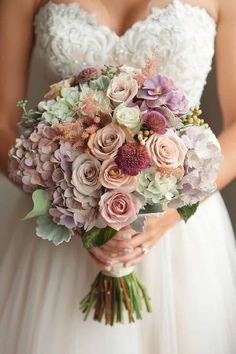 a bride holding a bouquet of flowers in her hands