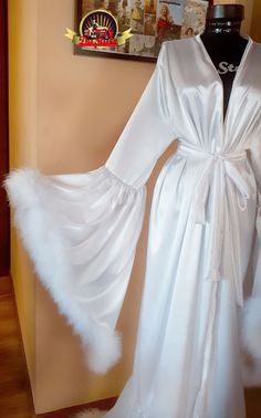 Feathered Robe For Wedding Night, Elegant Wedding Robe With Feathers, Long Sleeve Feather Robe For Parties, Elegant Robe With Feather Trim For Wedding Night, Wedding Satin Robe With Feathers, Elegant Satin Robe With Feathers, Elegant Party Robe With Feather Trim, Elegant Feathered Evening Robe, Feathered Dresses For Wedding Night