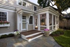 a house with white trim and wood steps