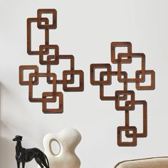 the wall sculpture is made out of wood and has square shapes on it, as well as a horse figurine