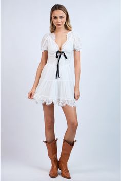 Flaunt your sweet and sassy side in the Te Amo Lace Mini Dress. Made from soft lace and a sheer lined layered fabric, this dress features a flattering neckline adorned with a black velvet bow tie detail. The open back also has a contrast tie that adds a playful touch. Perfect for showing off your unique style! Color: White Mini Length Floral Embroidered Lace Flattering NeckLine With Scalloped Edge Lace Short Puff Sleeve Contrast Front Velvet Tie Bow Open Back With Velvet Tie Bow Scalloped Lace Hemline Lined Fabric 100% Polyester Flirty Lace Mini Dress With Lace Trim, Coquette Lace Trim Dress For Date Night, Lace Mini Dress For Date Night, Flirty Lace Patchwork Dress, Feminine Mini Dress With Contrast Lace, Flirty Lace Dress For Brunch, Delicate Lace Mini Dress For Daywear, Chic Lace Trim Dress For Brunch, Flirty Lace Dress With Lace Sleeves