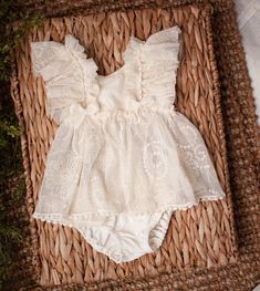 Cheyenne is a two piece set. The dress is designed with an ivory floral embroidered fabric and is trimmed in pom poms and velvet bows. Matching bloomers included. This set is designed to fit size 12 months. Sizing is flexible and this may fit older babies. Some items are ready to ship however, please allow up to 14 days for your order to ship. Items are carefully crafted by hand just for you. If you have a specific date you need an order by, please feel free to contact me. We work hard to size o Spring Cotton Sets With Lace Trim, Cotton Sets With Lace Trim For Spring, Spring Beige Ruffled Sets, Embroidered Cream Sets For Spring, Fitted Beige Sets With Ruffles, White Lace Trim Sets For Spring, Cream Lace Ruffle Dress For Baptism, Cream Ruffled Lace Dress For Baptism, Summer Cotton Lace Dress With Ruffles