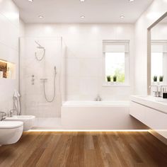 a white bathroom with wood flooring and lights on the ceiling above the bathtub