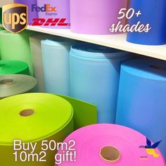 various colored rolls of toilet paper are on display in a store with the price tag below