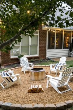 an outdoor fire pit surrounded by lawn chairs