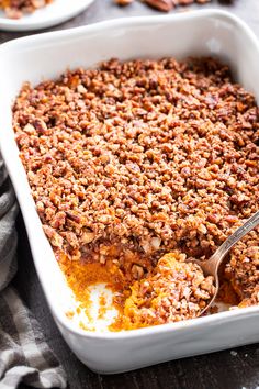 a casserole dish filled with carrots and pecans