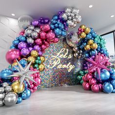 an entrance to a party decorated with balloons and starfish