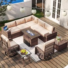 an outdoor living room with wicker furniture