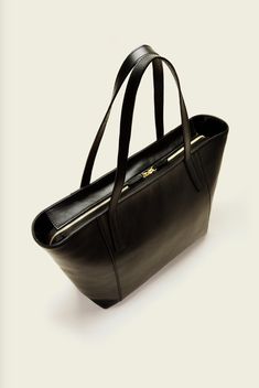 "A tote that will heighten your everyday lifestyle with sophistication. Pronounced and thick horizontal stitching along the body of the bag; to allude emphasis of it's shape. Your items remain secure inside, with two zippers attached to a leather closure. L 18 x H 11 x W 5 inches Handle Drop 10\"  Zipper Opening  One Interior Zip Pocket Attached Coin Purse with Clip For Keys Two Interior Pockets  Durable Satin Lining Italian calf skin Designed and Handcrafted in Brooklyn, NY" Travel Bag, Purses And Handbags, Gym Bag, Calf Skin, Leather Bag, Shoulder Bags, Zip Pockets, Brooklyn, Coin Purse