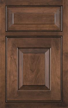 an image of a kitchen cabinet door with wood grained finish and square knobs