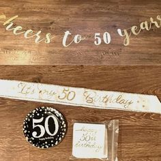 the 50th birthday cake is next to a sign that says, cheers to 50 years