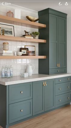 an image of a kitchen setting with green cabinets