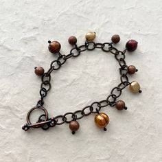 7" length for average size wrist Bronze Pearl Rustic Chain bracelet with beautiful shades of brown pearls. This bracelet is so classic but modern on the rustic chain. Besides the pearls there are also bronze shimmery metal beads in between. Brown Pearls, Women Artist, Rustic Bracelet, Dangle Bracelet, Bronze Bracelets, Artist Business, Shades Of Brown, Story Inspiration, Metal Beads