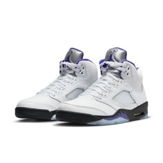 The Air Jordan 5 Retro Concord brings a classic color scheme with a modern twist. It features a sleek white leather upper, TPU netted underlays, and a reflective tongue all contrasted by accents of Concord found on the Jumpman logos, midsole shark teeth, and sockliner. Black is seen on the midsole with an Air cushioning heel unit and semi-translucent icy outsole finishing the design. A must-have for any sneaker fan's collection, this pair contributes throwback style to any look. Classic Basketball Shoes With Abzorb Midsole, Classic White Basketball Shoes With Contrast Sole, Classic White Basketball Shoes, Classic Leather Sneakers With Padded Tongue, Classic White Sneakers With Padded Tongue, Classic White Leather Basketball Shoes, Jordan 5 Concord, Jordan 5s, Nike Air Jordan 5