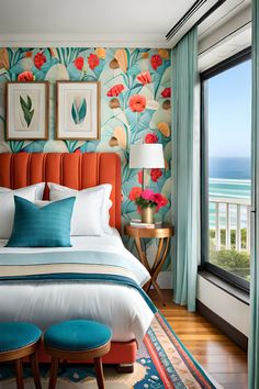 a bedroom with an ocean view and colorful wallpaper