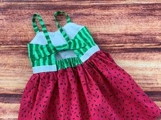 "Your science loving little girl will love her fun watermelon twirl dress!!  So perfect for a picnic, a garden party, a birthday gift or everyday fun with the perfect twirling factor! The bodice features a sweetheart neckline and is lined in a white cotton fabric.  The keyhole back ties with a knot with elastic at the back for a comfortable fit. The dress is easy care 100% cotton with the perfect twirling factor!  So much fun for play, parties and dress up occasions. There is an option available Playful Summer Twirl Dress For Garden Party, Playful Green Sundress For Vacation, Cute Summer Twirl Dress For The Beach, Fun Summer Holiday Dresses, Cute Strawberry Print Dress For Vacation, Cute Strawberry Print Vacation Dress, Cute Summer Twirl Dress For Party, Fun Summer Party Twirl Dress, Playful Red Sundress For Summer