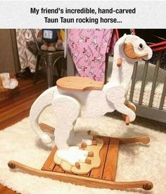 a wooden rocking horse sitting on top of a rug