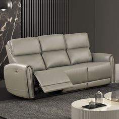 a modern living room with two reclining sofas and a coffee table in the middle