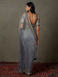 Editor's Note Elevate your style with our grey machine and hand-embroidered hasika sari, paired with a stitched blouse. This ensemble combines intricate embroidery with timeless elegance, making it a perfect choice for special occasions and celebrations, exuding grace and sophistication. Color: Gray Fabric: Nylon net Components: Sari and blouse Occasion: Reception Note: Product colour may slightly vary due to photographic lighting sources Care: Dry clean only About the DesignerRi Ritu Kumar is o Personal Shopping Service, Ritu Kumar, Ancient Designs, Intricate Embroidery, Gray Fabric, Photographic Lighting, Grey Fabric, Price Match, Hand Embroidered