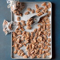 a tray filled with granola next to a bag of nuts