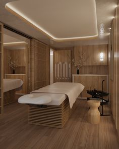 a spa room with two massage tables and wooden walls on either side of the room