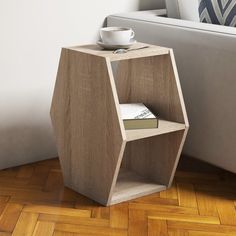 a wooden table with a cup on it next to a white couch in a living room