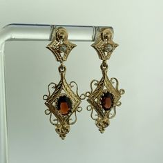 * Vintage 14K Yellow Gold Oval Garnet Seed Pearl Dangle Drop Earrings * Length: 1-7/16" * Width: 1/2" * Oval Garnets measure approximately 6.0 mm x 4.0 mm each * Seed Pearls measure approximately 1.90 mm each * Weight: 4.2 tgw * Marked: 14K * Fastening: Butterfly-NOT INCLUDED * Condition: As pictured. * G3407    Exported By ExportYourStore :) Elegant Oval Hallmarked Earrings, Formal Oval Earrings With Elegant Design, Oval Earrings With Elegant Design For Formal Occasions, Victorian Jewelry With Oval Matching Earrings, Yellow Gold Oval Filigree Earrings, Oval Yellow Gold Filigree Earrings, Oval Yellow Gold Earrings With Intricate Design, Elegant Oval Earrings With Intricate Design, Heirloom Earrings For Formal Occasions