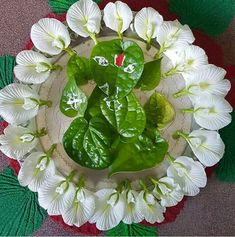 white flowers and green leaves on a plate